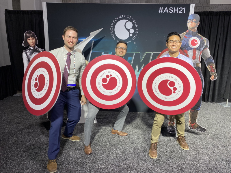 Three fellows with large shields in front of a Captain America cut-out