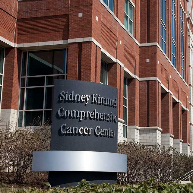 Image of the Sidney Kimmel Comprehensive Cancer Center sign in front of the Weinberg building.