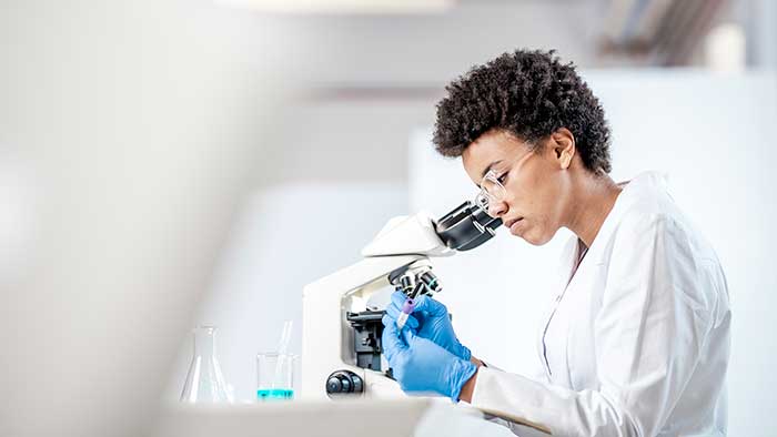 Young scientist with a microscope
