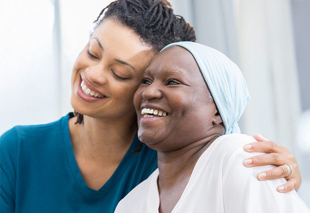 nurse hugging patient both smiling