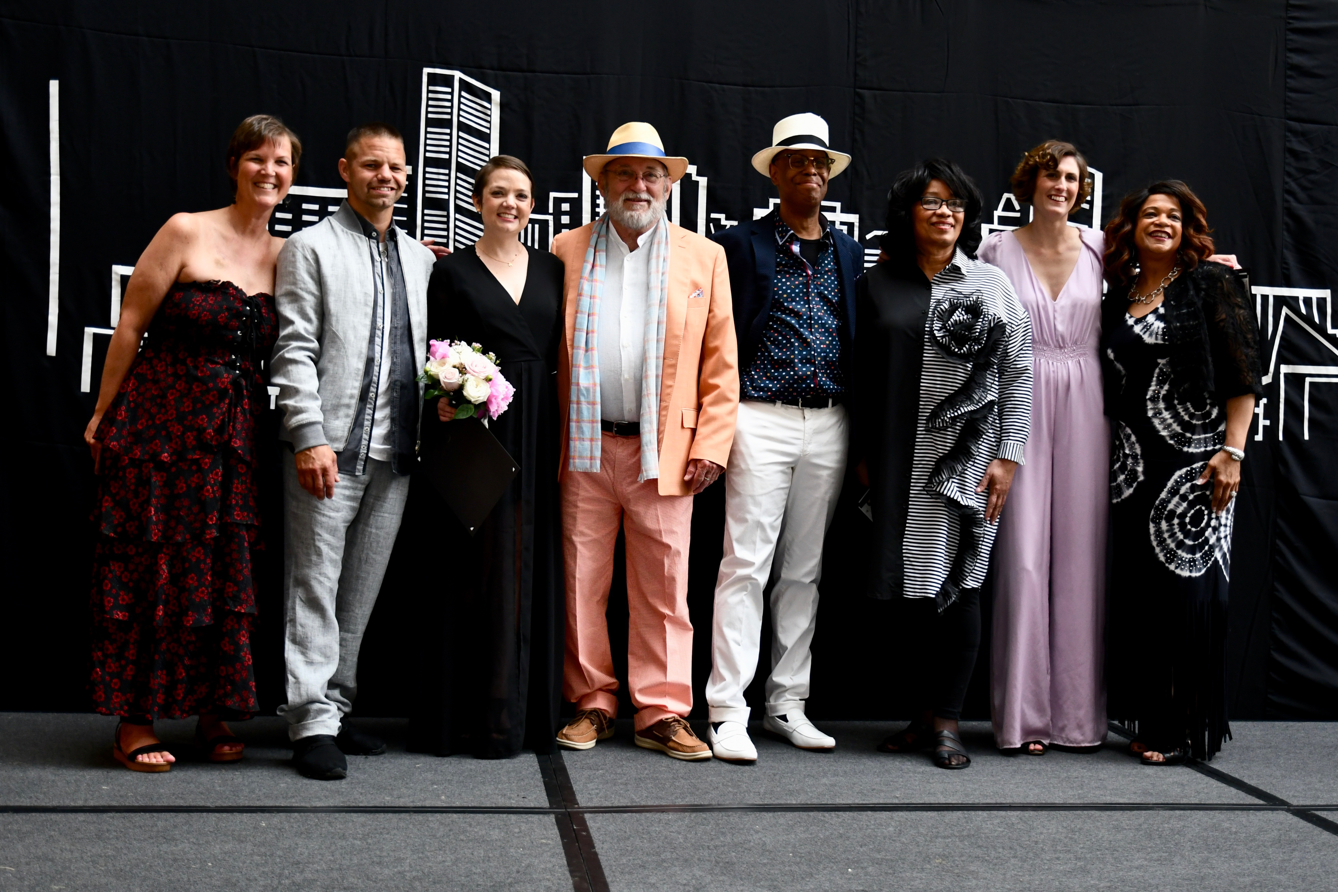 Fashion show models/survivors on stage.