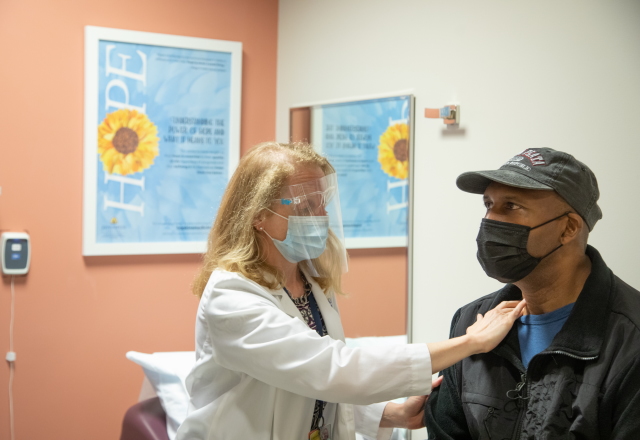 Masked provider caring for a patient