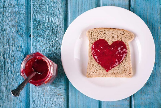 Jam spread on toast in the shape of a heart