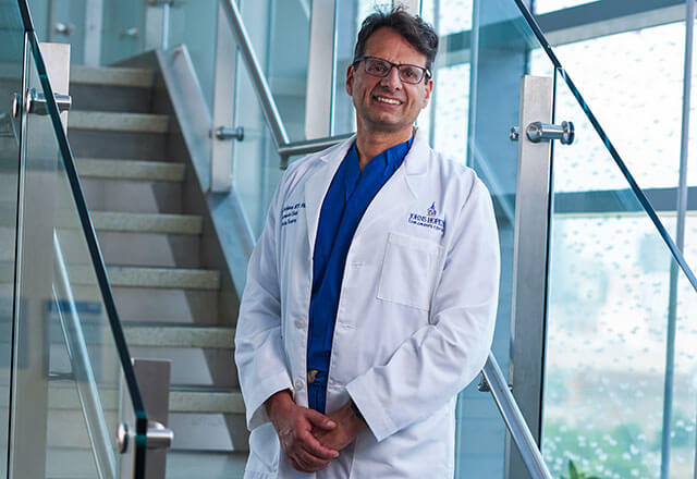 dr. joel hackam on a staircase
