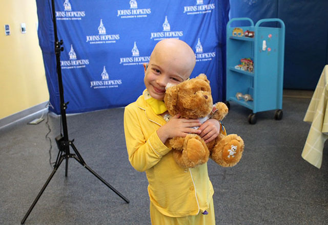child holding a teddy bear