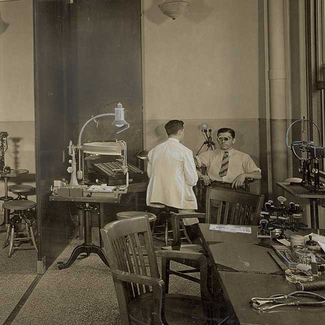 Black and white photograph showing an older patient exam room