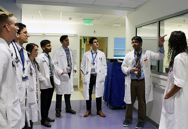 housestaff listening to a physician speak