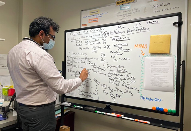 A resident using a white board.