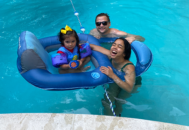 two residents in the pool with a child