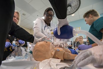 Students practicing CPR on a dummy.