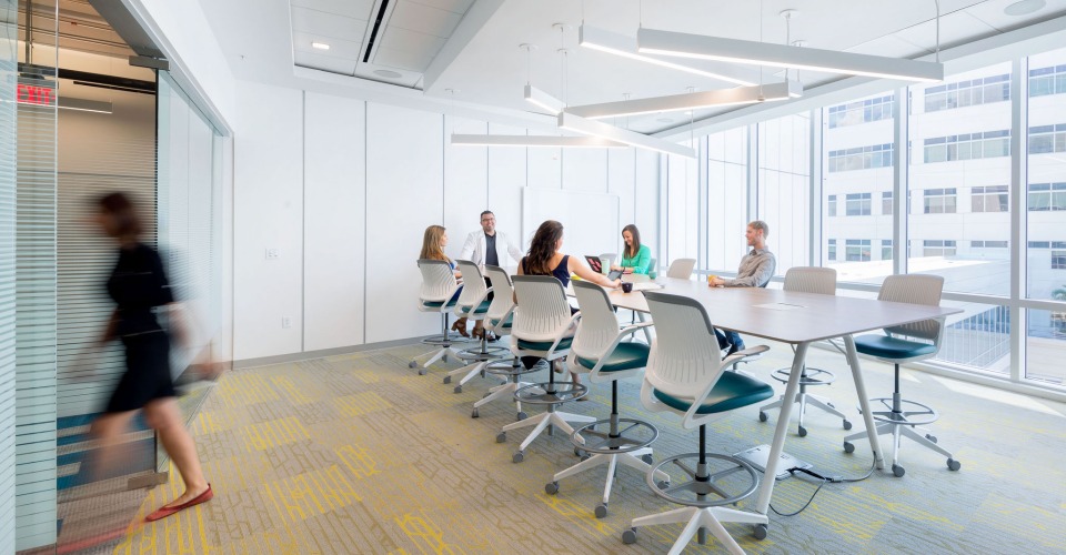 Colleagues in a large conference room within the Research and Education Building.