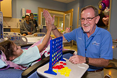 Owen Young, the volunteer of the year at Johns Hopkins All Children's Hospital, playing Connect 4 with a patient