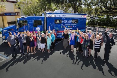 Guild members in front of the Johns Hopkins All Children's LifeLine ambulance, part of a $1.3 million pledge