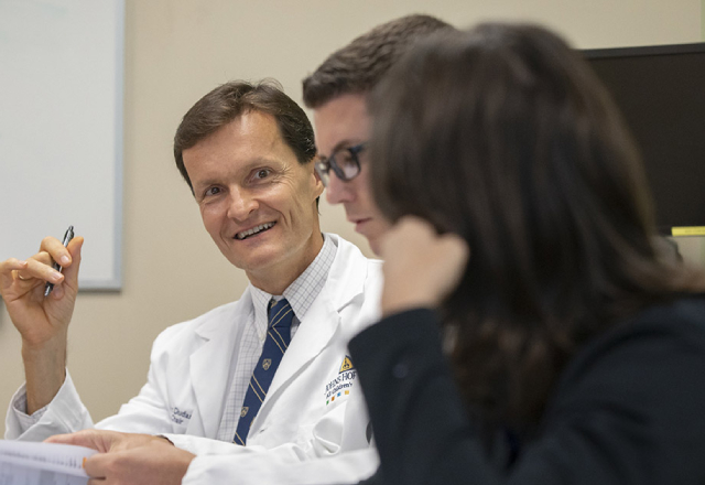 Bob Dudas, M.D., chief academic hospitalist at Johns Hopkins All Children's Hospital, leads a discussion with other hospitalists.