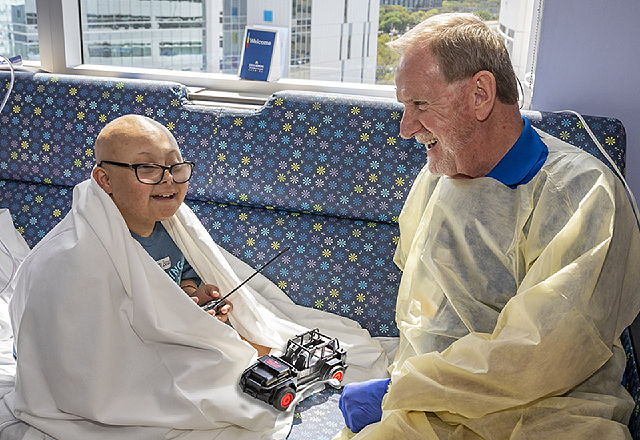 Johns Hopkins All Children’s volunteer Owen Young visits with patient Gabriel in early March before social and physical distancing and masking guidelines were announced.