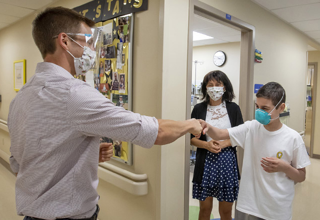 Dr. Oshrine with Svetoslav, a patient at Johns Hopkins All Children’s who is going home after 11 months of treatment for leukemia and a successful bone marrow transplant.