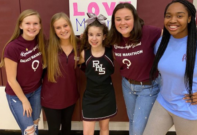 Marina (center), a patient at Johns Hopkins All Children's, became an honorary cheerleader and helped raise money for the hospital at Sarasota Riverview High’s Dance Marathon.