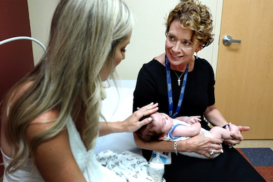 Karen Raimer, M.D., pictured with a patient in 2018