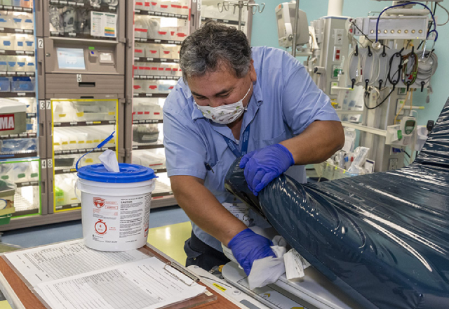Juan Gallardo, an environmental services technician at Johns Hopkins All Children's, disinfects a trauma room.