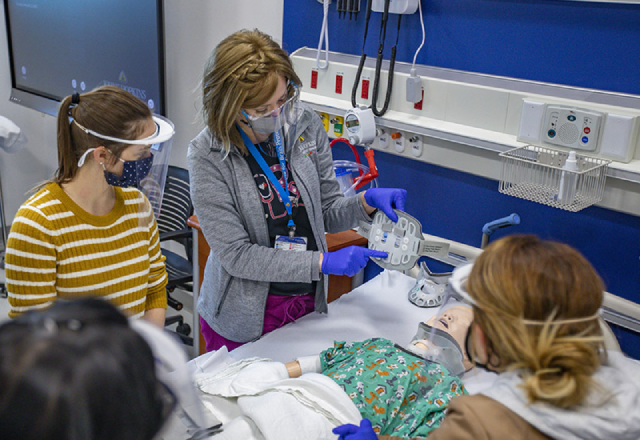 Amy Sullivan, R.N., leads a simulation for clinicians from Golisano Children's Hospital in the Simulation Center at Johns Hopkins All Children’s.