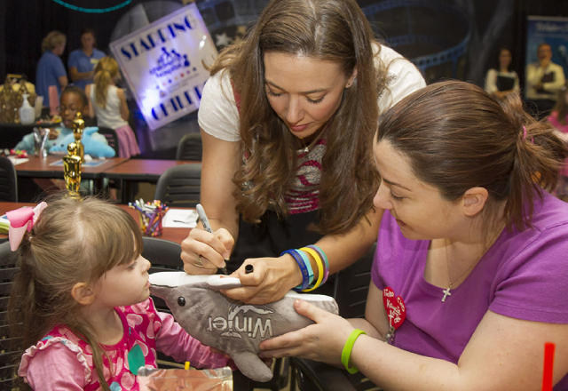 Austin Highsmith, who played Phoebe in both Dolphin Tale movies, signs autographs at the hospital in 2015.