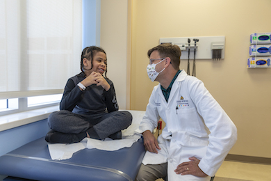 Matthew Smyth, M.D., with a patient