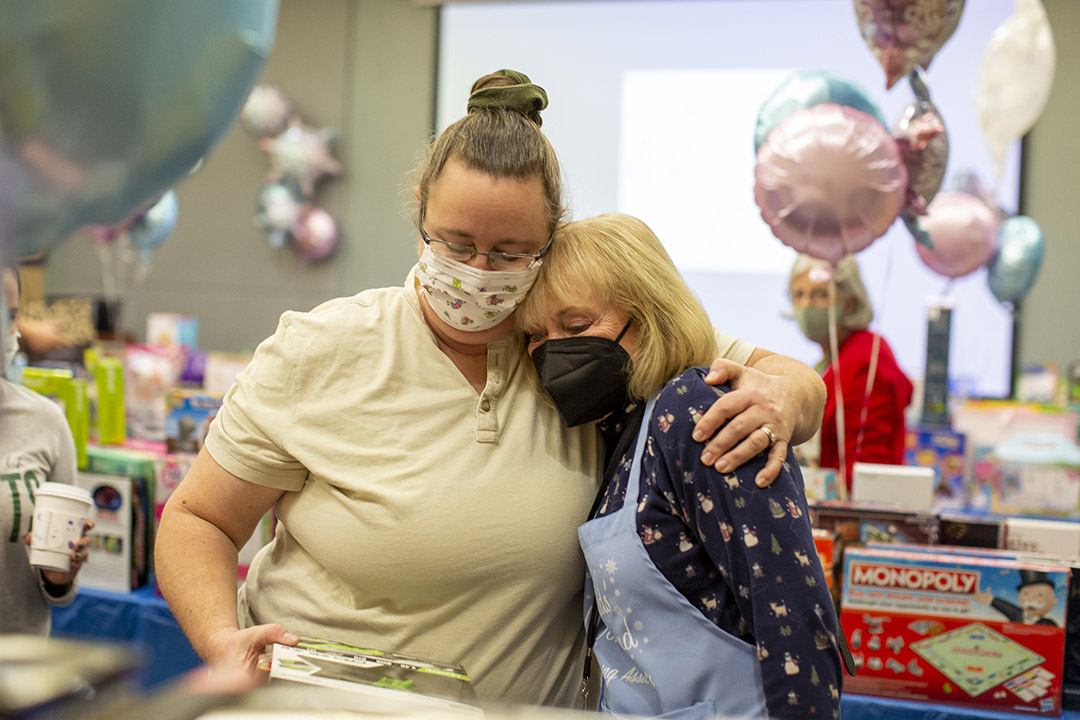 Grateful mom Victoria, left, hugs Kay Aidlin, who has been generous with her time and money.