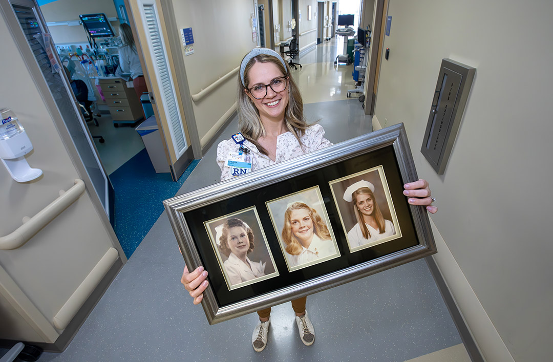 Jen Rykovich, M.S.N., R.N., CCRN, CHPPN, with the photo of her, her mother and her grandmother that she displays in her office at Johns Hopkins All Children's.