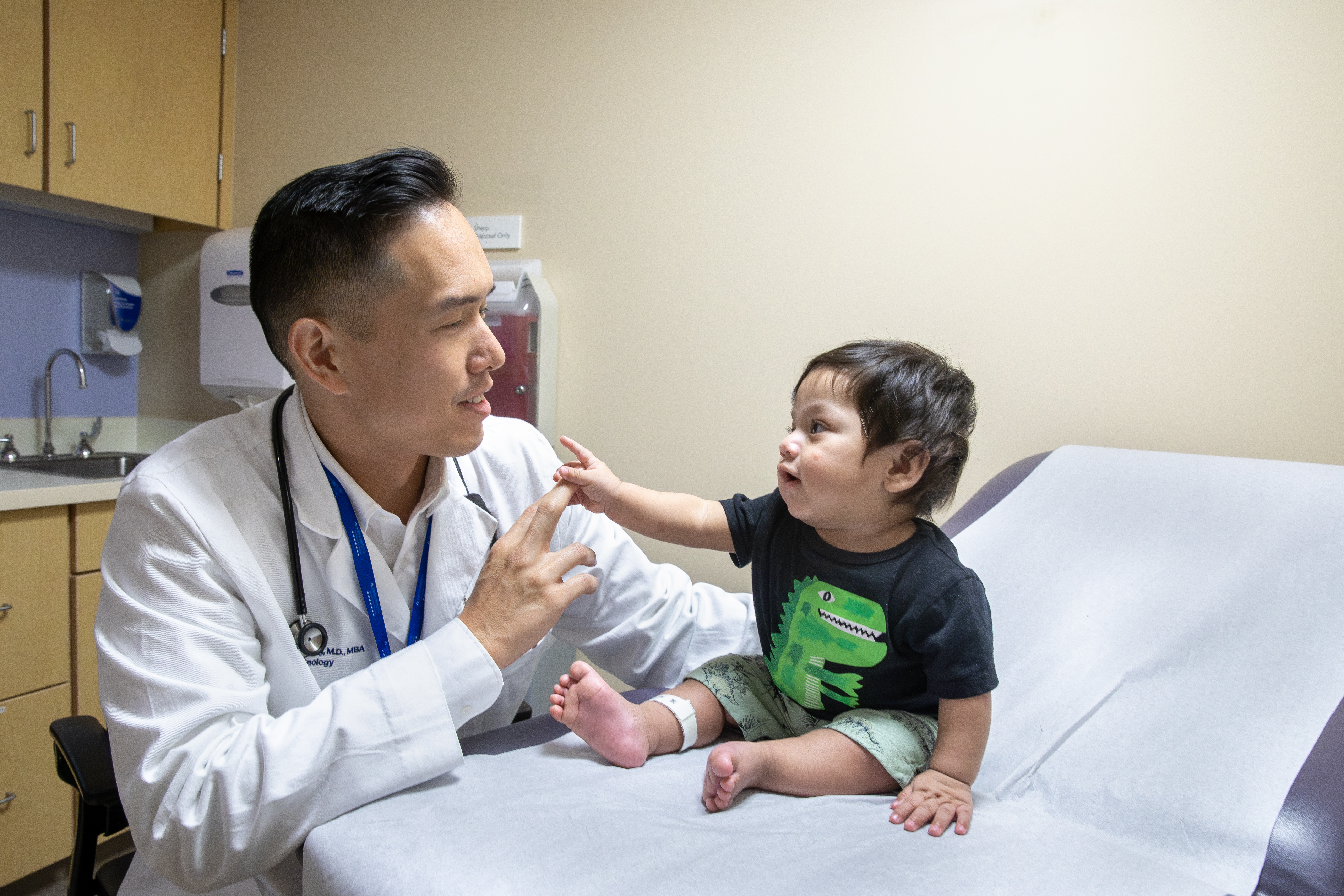 Supamit Ukarapong, MD MBA, with a young patient 