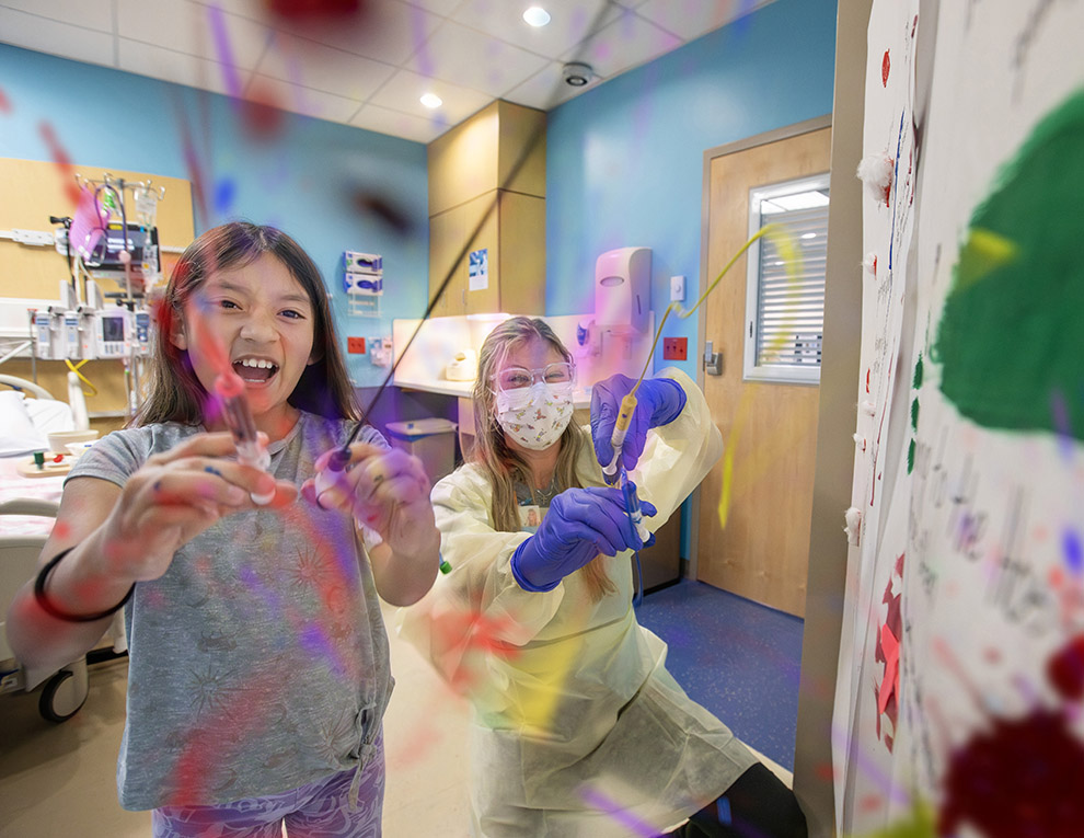 Child Life specialist Madison Dilgard with patient Yulisa