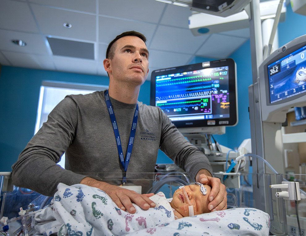 Evan Kansorka with a patient in the CVICU