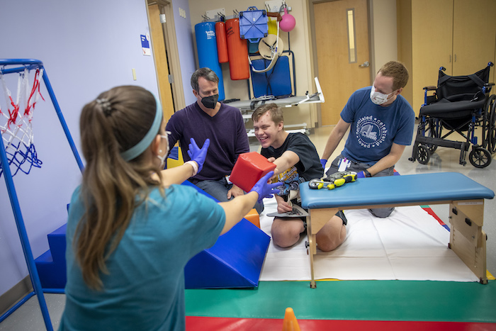 Patient Ethan working with the rehab team at Johns Hopkins All Children's Hospital