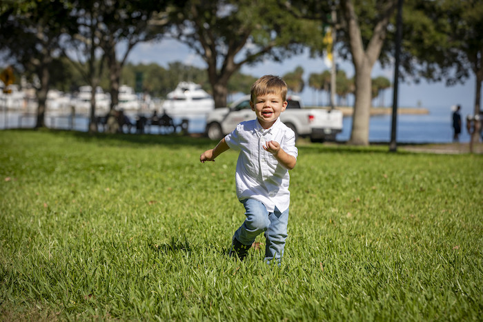 Patient Ethan running around outside in a park