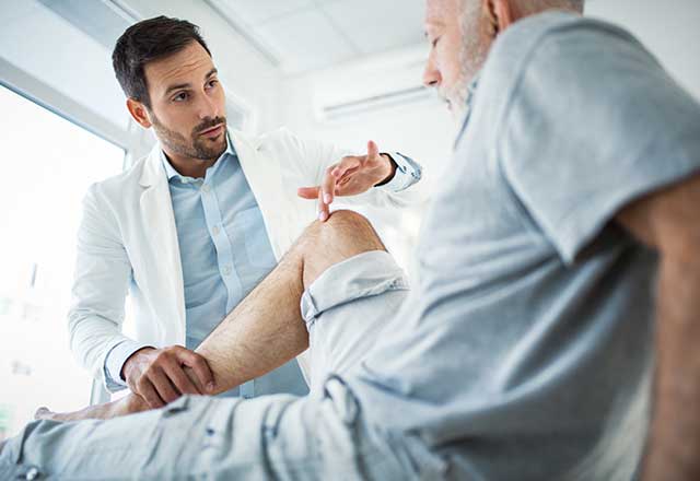 Provider examining a patient's knee.