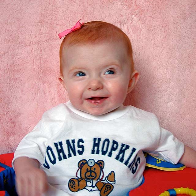 Carson wearing a Johns Hopkins t shirt as a baby