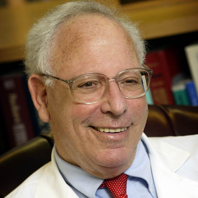 Dr. John Freeman in a white coat
