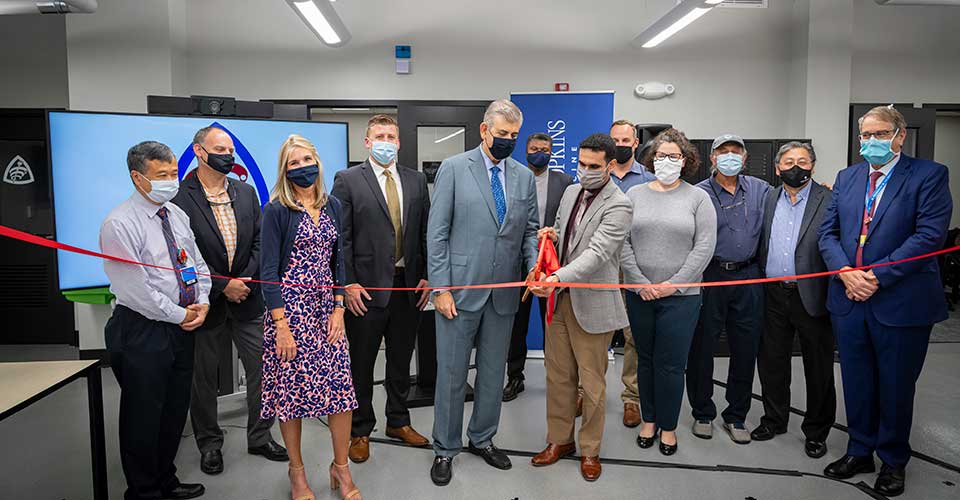 Lab members cutting a ribbon during an opening celebration