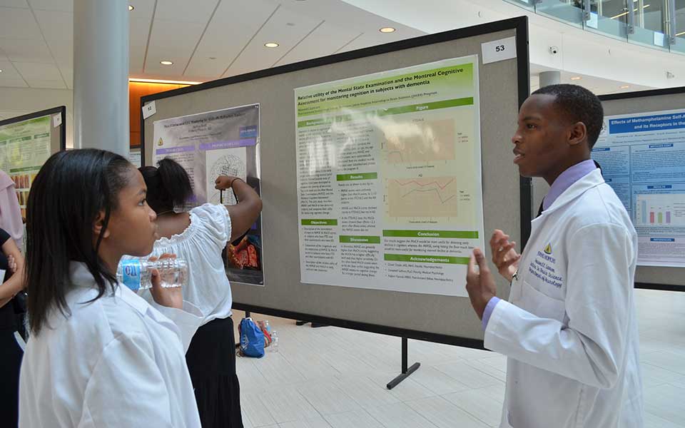 An intern of 2014 presenting a poster
