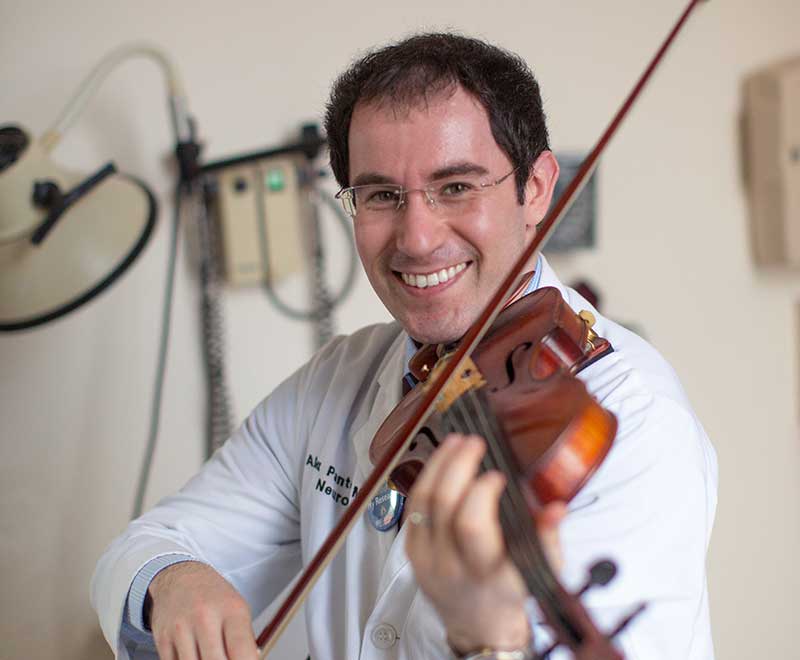 Dr. Pantelyat playing a violin
