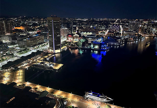 Picture of the Baltimore Inner Harbor at night.
