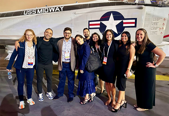 The Johns Hopkins NCCU group standing in front of a fighter jet.