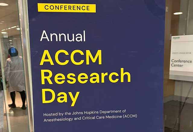 A dark blue banner sign that says Annual ACCM Research Day