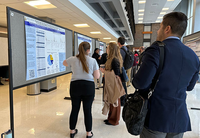 Picture of Brooke Honzel and Mahima Kotamreddy in front of their poster presentations.