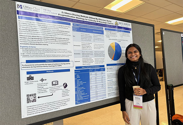 Mahima Kotamreddy standing in from of her poster presentation.