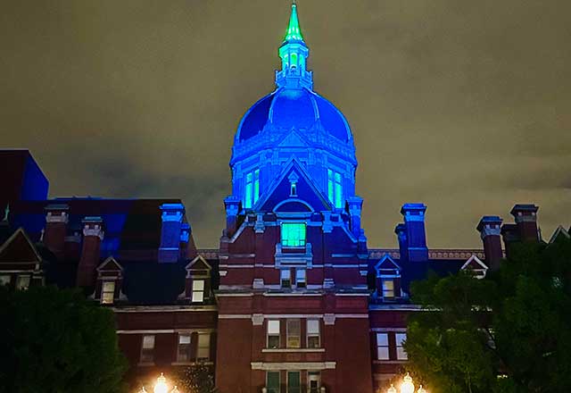 The dome of the Billings Building on the East Baltimore campus is lit up in blue in honor of the NF awareness month.
