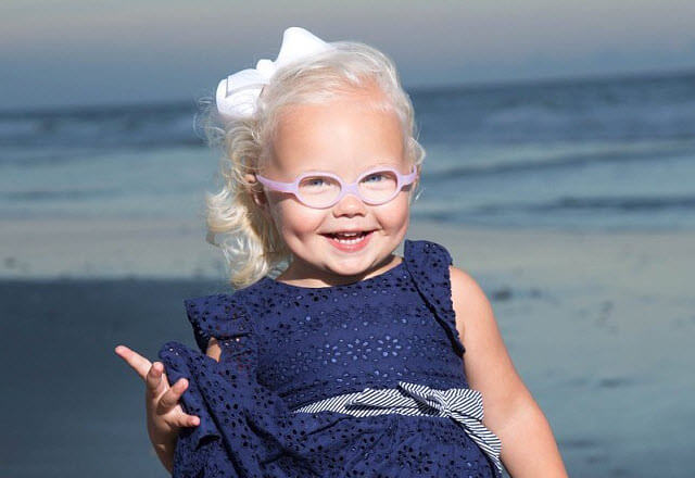 Adelynn smiling in front of the ocean