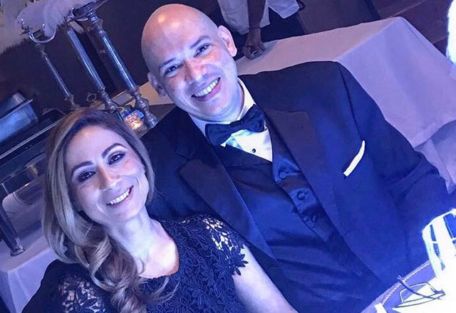 Pedro poses with his wife at a wedding