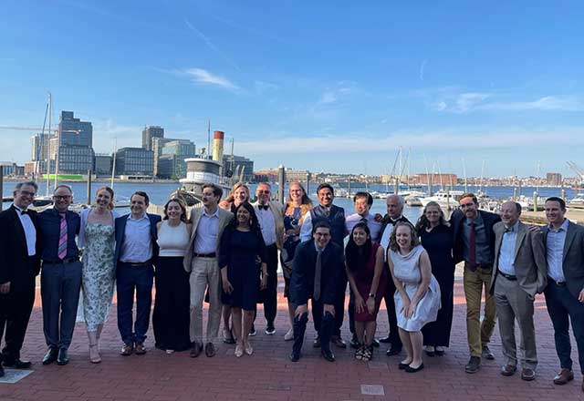 A group of pediatric neurology faculty and residents posing in Baltimore's inner harbor.