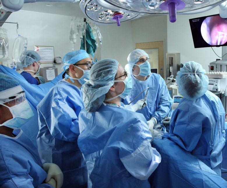 Neurosurgeons operating a surgical robot