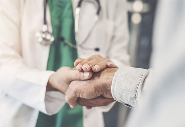 doctor holds patient hand